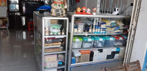 a room with two shelves filled with lots of items at Nhà Trọ Kim Ánh in Long Xuyên