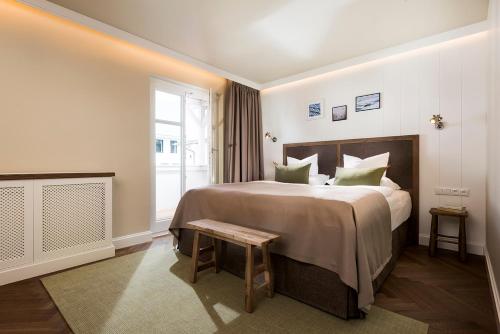 a hotel room with a large bed and a window at LOEV - VELA Hotels in Binz