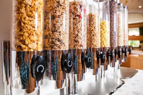a row of cereals are lined up on a counter at Hotel & Appartements Alpenresidenz Viktoria in Neustift im Stubaital