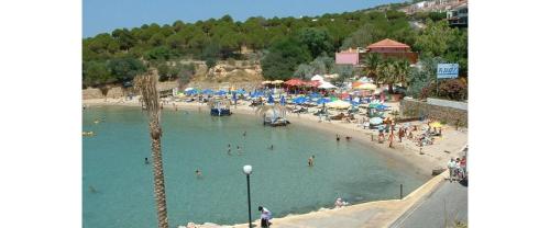 a beach with a bunch of people in the water at Antik Ridvan Hotel in Cesme