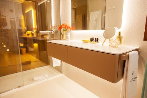 a bathroom with a sink and a shower at Augusta Eco Wellness Resort 4 Superior in Sanxenxo