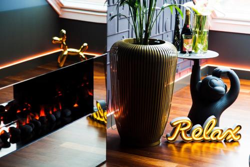 a black cat vase sitting next to a wine cellar at Augusta Eco Wellness Resort 4 Superior in Sanxenxo
