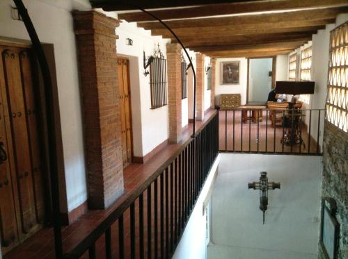 a swimming pool in a house with a cross in the floor at Posada de la Mision, Hotel Museo y Jardin in Taxco de Alarcón