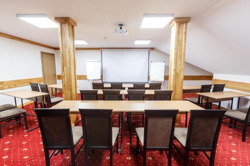 a conference room with tables and chairs and a whiteboard at Baron SPA Hotel - Museum Yaremche in Yaremche