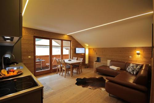 a living room with a couch and a table at Villa Natur in Schröcken