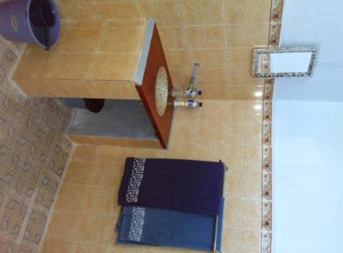 a shower in a bathroom with a towel on the floor at Leko Lembo Guesthouse in Keli
