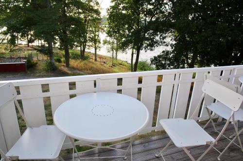 a white table and two chairs on a porch at Trollebo Säteri in Vetlanda