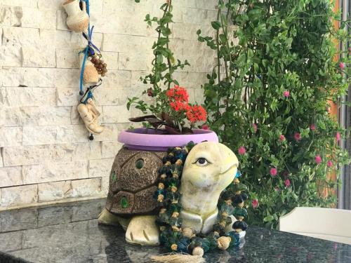 a statue of an elephant with a flower pot on a table at Rota Hotel in Dalyan