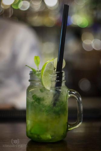 a mason jar filled with a green drink with a straw at Hotel Kresowiak in Siemiatycze