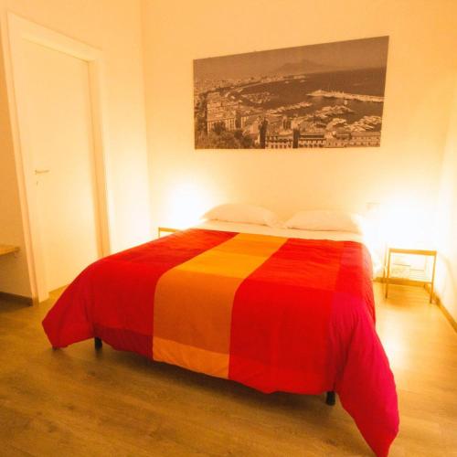 a bed with a colorful blanket on it in a room at Monaciello in Naples