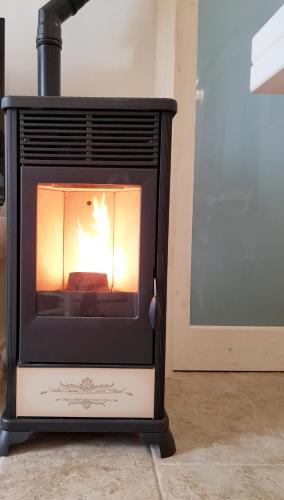 a stove with a fire inside of a room at BiancoAmore OSTUNI - the sky, the sea, the love - in Ostuni