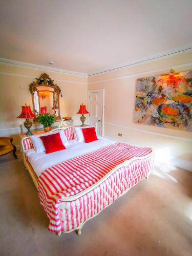 a bedroom with a large bed and a mirror at Cedar House Boutique B&B in Burton