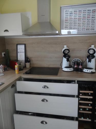 a kitchen with white drawers and a counter at circuit expo zenith in Le Mans