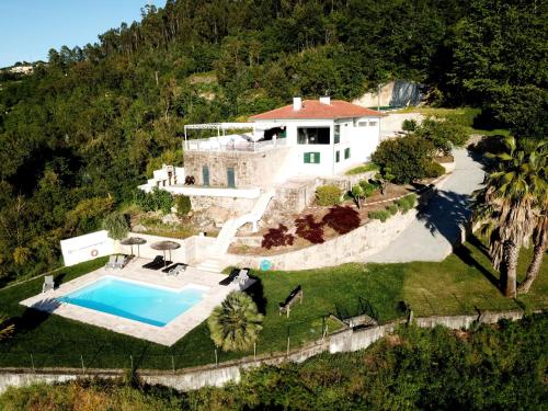 an aerial view of a house with a swimming pool at Quinta das Tílias Douro Valley in Cabaça
