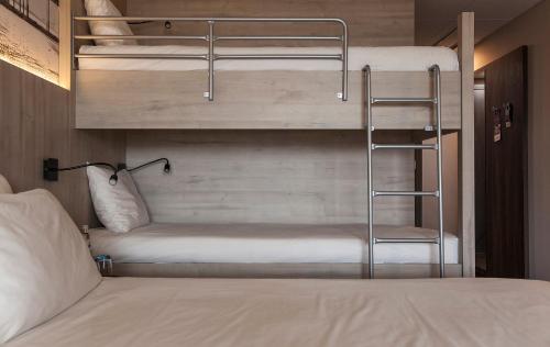 a bedroom with two bunk beds and a bed at Mercure Blankenberge in Blankenberge