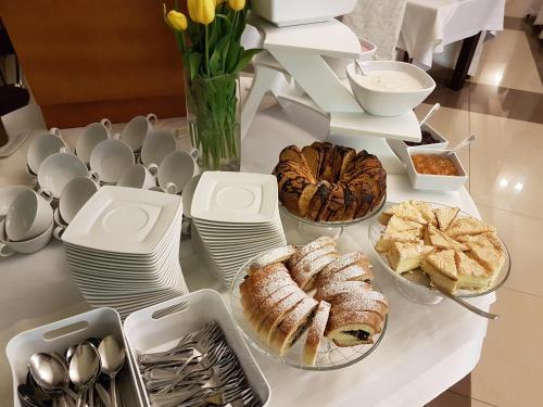 a table with various pastries and croissants on it at Hotel Zimnik Luksus Natury Spa & Wellness in Szczyrk