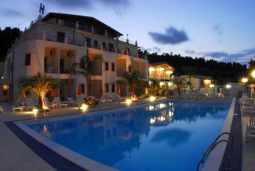 a hotel with a swimming pool in front of a building at Hotel Orchidea in Peschici