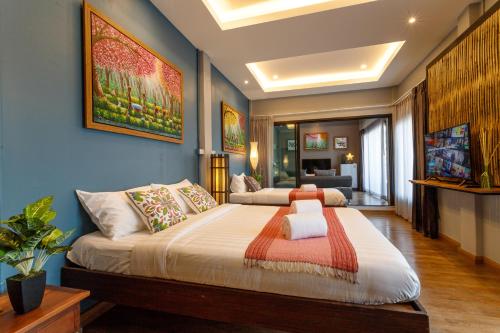 a bedroom with a large bed with blue walls at Hostel One Art and Gallery in Chiang Mai