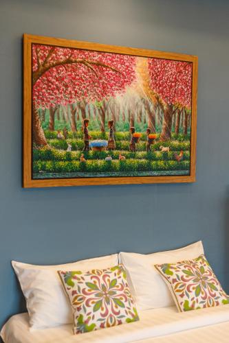 a painting on the wall above a couch at Hostel One Art and Gallery in Chiang Mai