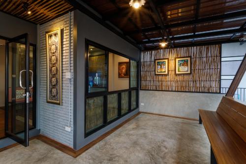 an empty room with a staircase and windows at Hostel One Art and Gallery in Chiang Mai