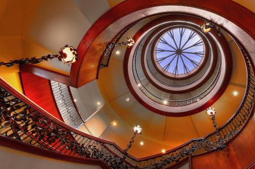 a spiral staircase with a round window at French Quarter Inn in Charleston