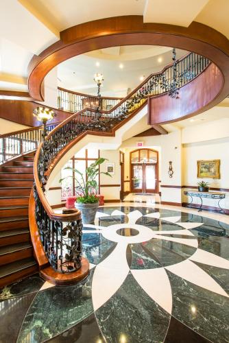 an ornate lobby with a spiral staircase and aoyer with a floor at French Quarter Inn in Charleston