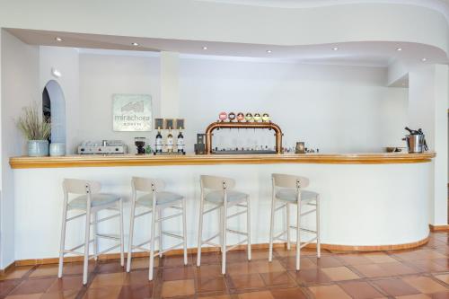 
a kitchen with a dining room table and chairs at Mirachoro Carvoeiro in Carvoeiro
