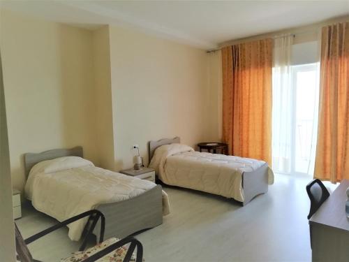 a hotel room with two beds and a window at Stella Maris Casa per ferie sul mare in Anzio