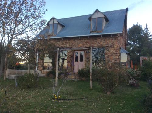 a brick house with a blue roof at BARE NECESSITIES, NUDIST ONLY VENUE Naturist, clothes free in Swellendam