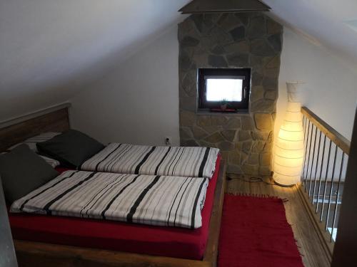 a bedroom with a bed and a tv on a wall at Apartmany Janosikove diery in Terchová
