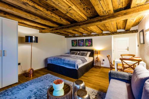 a bedroom with a bed and a couch at APT. STONE-LODGE in Salzburg