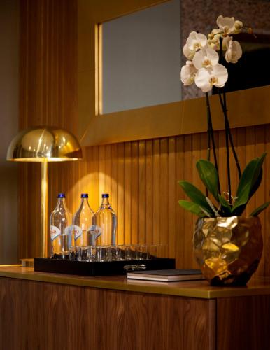 a table with three bottles and glasses on it at Altis Suites Apartamentos Turísticos in Lisbon