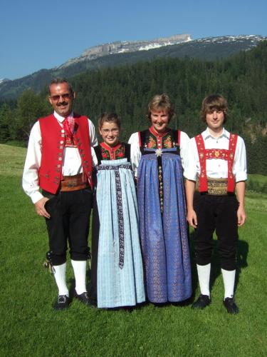 a group of people in traditional clothing standing in a field at Gästehaus Boersch in Riezlern
