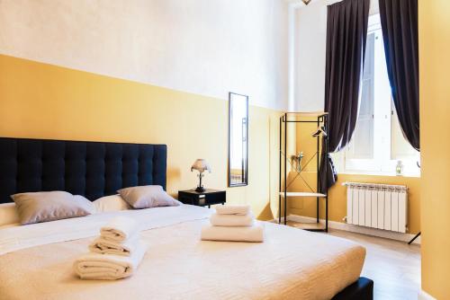 a bedroom with a bed with towels on it at B&B Lumiere Roma in Rome