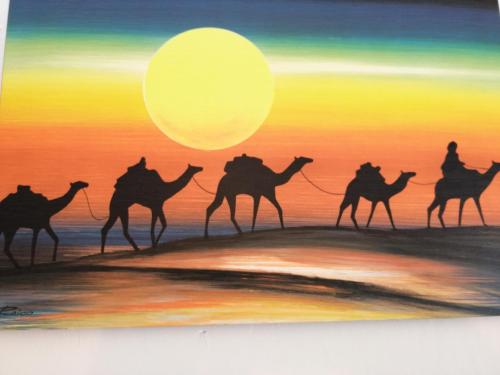 a painting of camel riders on the beach at sunset at Holiday Home Zolfare in Comitini