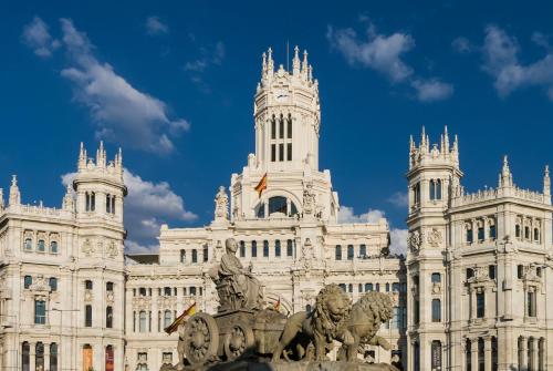 a large building with a statue in front of it at Exclusive quietness in the heart of Madrid with Public Parking, Breakfast, 2 bathrooms in Madrid