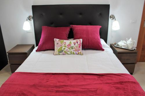 a bedroom with a large bed with pink pillows at El Mirador de Tabaiba in Tabaiba