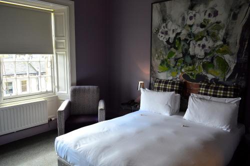a bedroom with a white bed and a window at B+B Edinburgh in Edinburgh