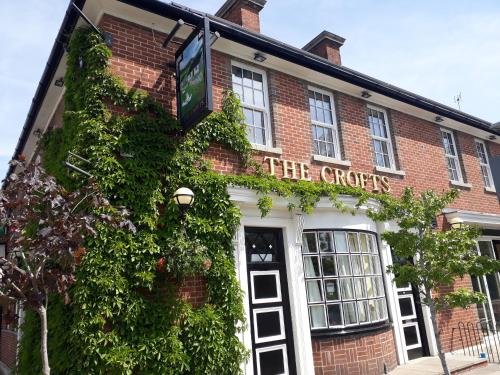 a brick building with a sign that reads the creeps at Crofts Hotel in Cardiff