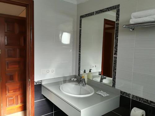 a bathroom with a sink and a large mirror at Gabiete in Puerto del Carmen