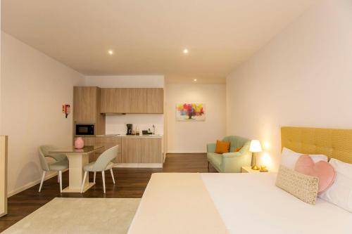a bedroom with a bed and a living room and a kitchen at Casa de Cristal by Oporto Soul in Porto