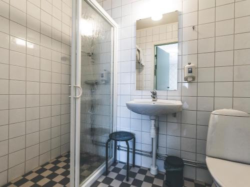 a bathroom with a sink and a toilet and a mirror at Wångens Wärdshus in Alsen