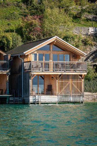 a house on a dock on the water at Hotel Zimmerbräu in St. Wolfgang