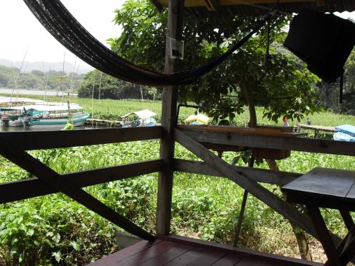 a view from the porch of a house with a fence at Reserva Ecologica Nanciyaga in Catemaco