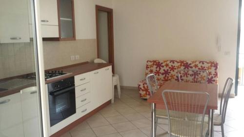 a kitchen with a table and a dining room at Casa degli Oleandri in Roccalumera