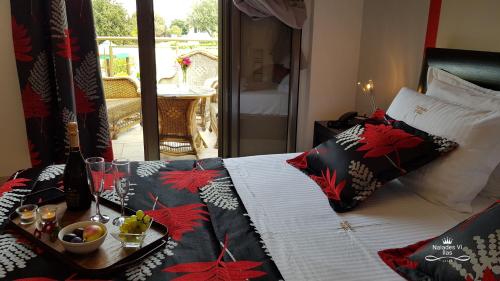 a bed with pillows on it with a table on it at Naiades Villas in Kato Achaia