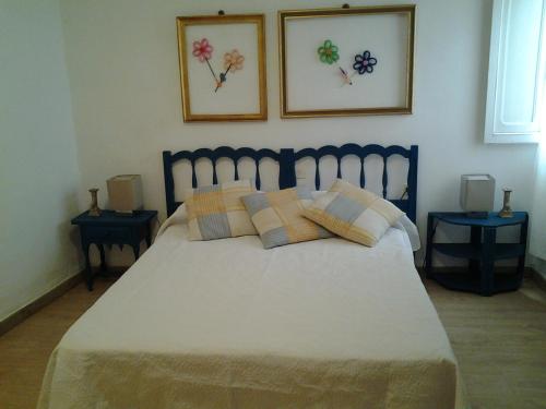 a bedroom with a large bed with two tables at casita bonita in Vinaròs