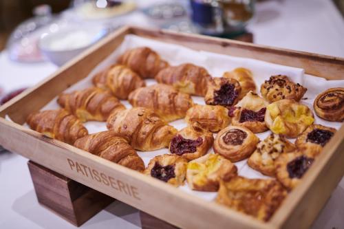 a box of different types of pastries on display at County Hotel in Chelmsford