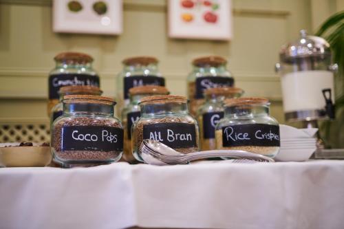 a group of glass jars of spices on a table at County Hotel in Chelmsford