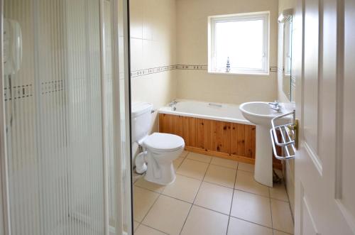 a bathroom with a toilet and a sink at Cottage 102 - Ballyconneely in Ballyconneely